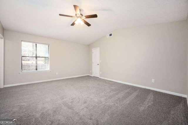 carpeted empty room featuring ceiling fan and vaulted ceiling