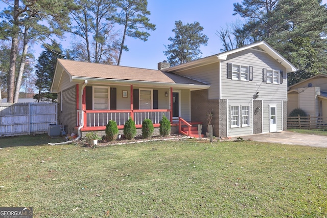 view of front of home featuring covered porch, central AC, and a front yard