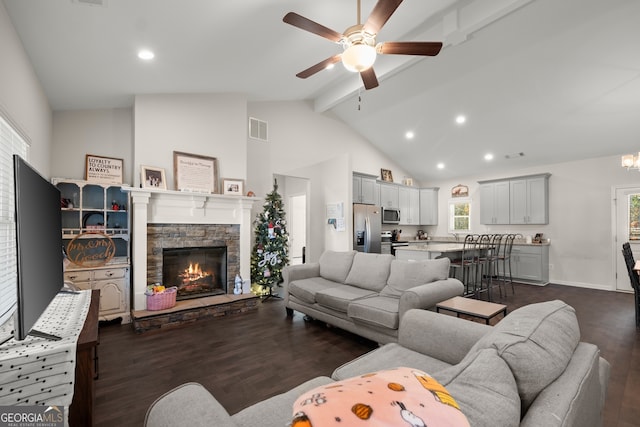 living room featuring high vaulted ceiling, a stone fireplace, ceiling fan, beamed ceiling, and dark hardwood / wood-style flooring