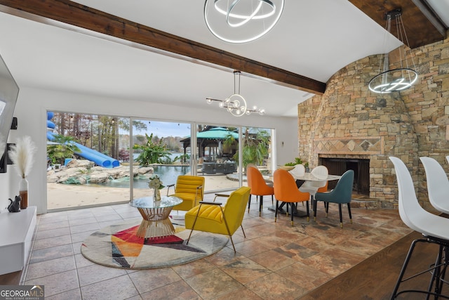 dining area with vaulted ceiling with beams, a fireplace, wood-type flooring, and an inviting chandelier