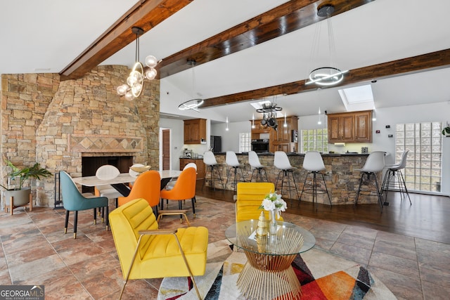 interior space featuring vaulted ceiling with beams and a stone fireplace