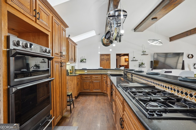 kitchen with appliances with stainless steel finishes, dark hardwood / wood-style flooring, ornamental molding, sink, and lofted ceiling with beams