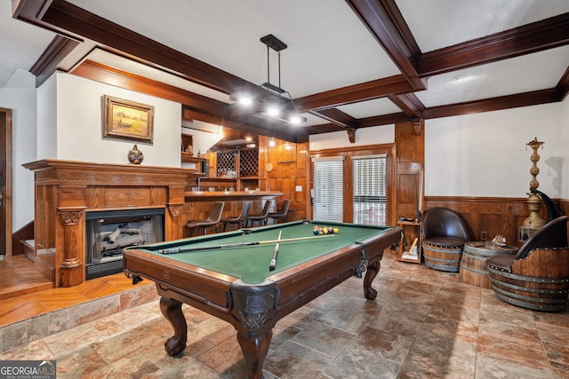 playroom with wooden walls, ornamental molding, pool table, bar, and beam ceiling