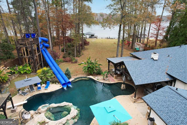 view of pool featuring a patio area, an in ground hot tub, and a water view