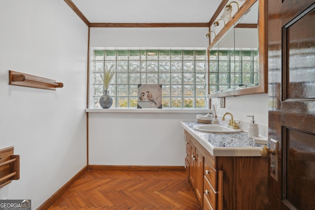 bathroom with vanity, ornamental molding, and parquet flooring