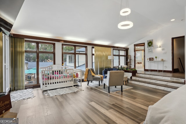 bedroom featuring wood-type flooring and vaulted ceiling