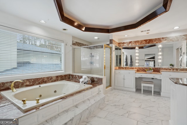 bathroom with a tray ceiling, plus walk in shower, and vanity