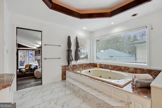 bathroom featuring a healthy amount of sunlight and a bath