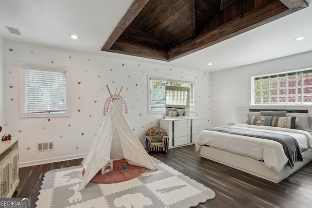 bedroom featuring beam ceiling and dark hardwood / wood-style floors