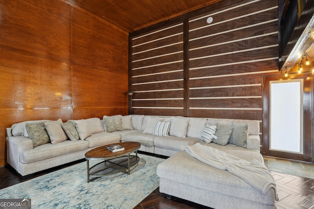 living room with dark parquet floors and wood walls