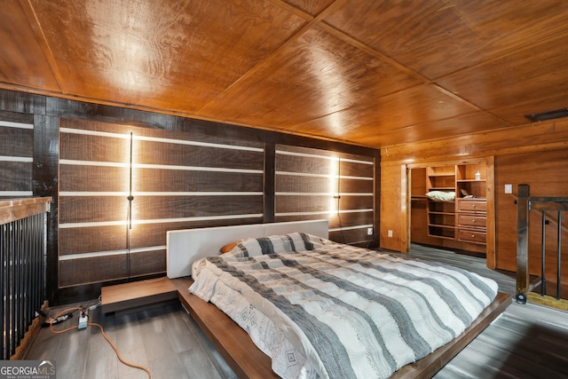 bedroom with dark hardwood / wood-style floors, wooden ceiling, and wood walls