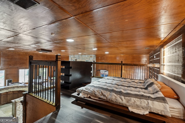 bedroom with wooden walls and wooden ceiling