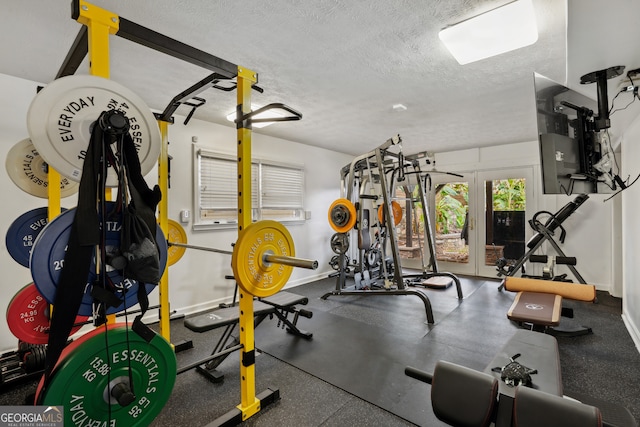 exercise room with a textured ceiling