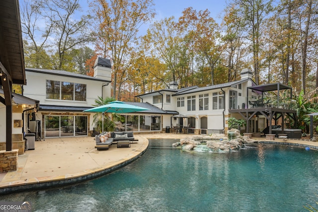 back of property with an outdoor hangout area and a patio area