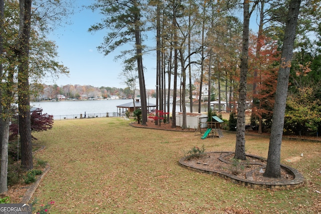 view of yard with a playground and a water view