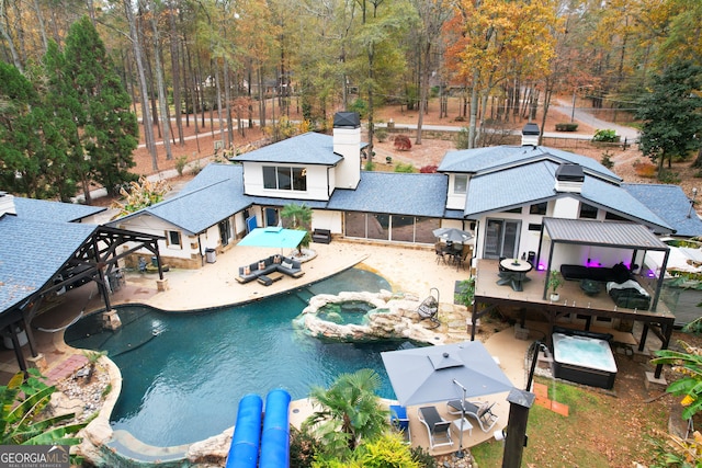 view of pool featuring a patio area and an in ground hot tub