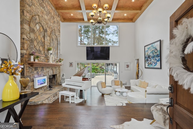 living room featuring hardwood / wood-style flooring, wooden ceiling, a fireplace, and an inviting chandelier