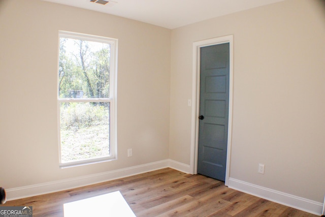 spare room featuring light wood-type flooring