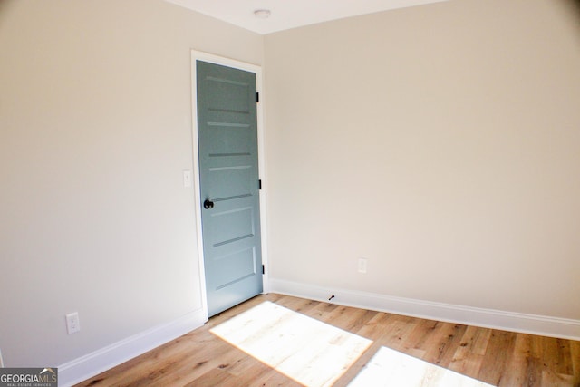 unfurnished room with light hardwood / wood-style flooring