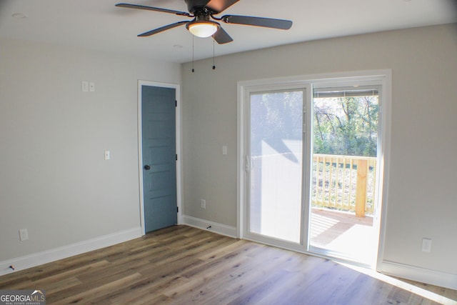 empty room featuring ceiling fan and hardwood / wood-style floors