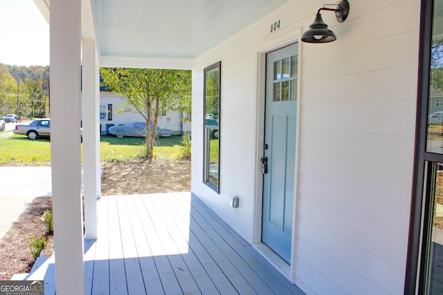 wooden terrace featuring covered porch