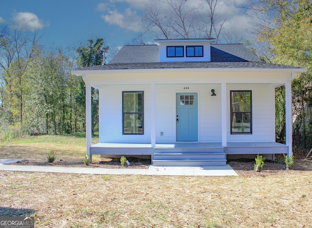 view of front of home featuring a front yard and a porch