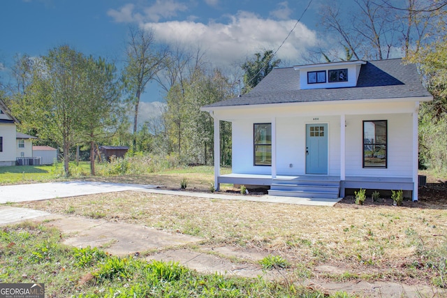 view of front of home with cooling unit and covered porch