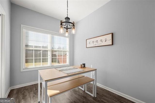 dining area with a chandelier, dark wood-type flooring, and a healthy amount of sunlight