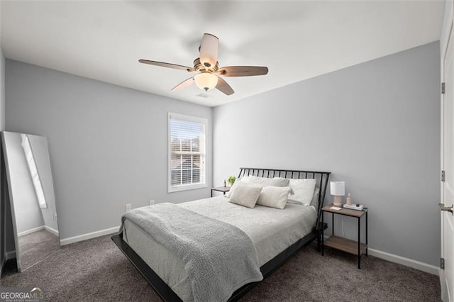 bedroom with ceiling fan and dark carpet