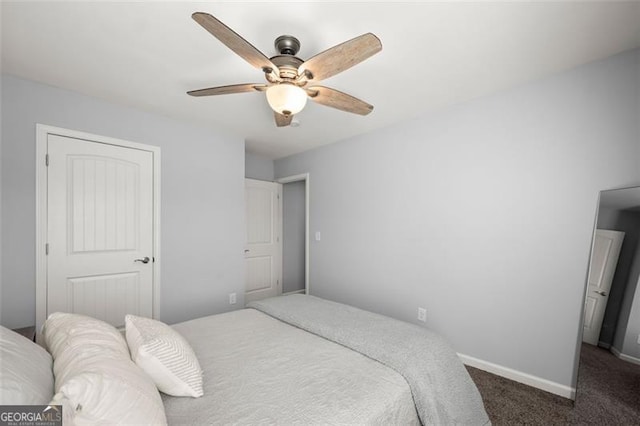 bedroom with ceiling fan and dark carpet