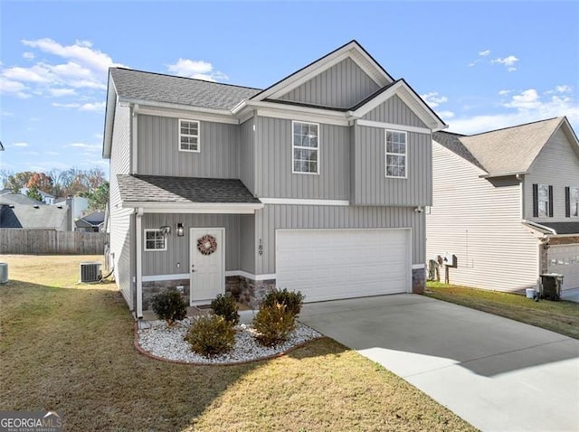 view of front of house featuring a front yard, central AC, and a garage