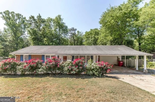 single story home with a front lawn and a carport