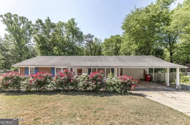 2982 Woodhaven Cir, Macon, GA 31204 - ranch-style house with an attached carport, concrete driveway, and view of wooded area