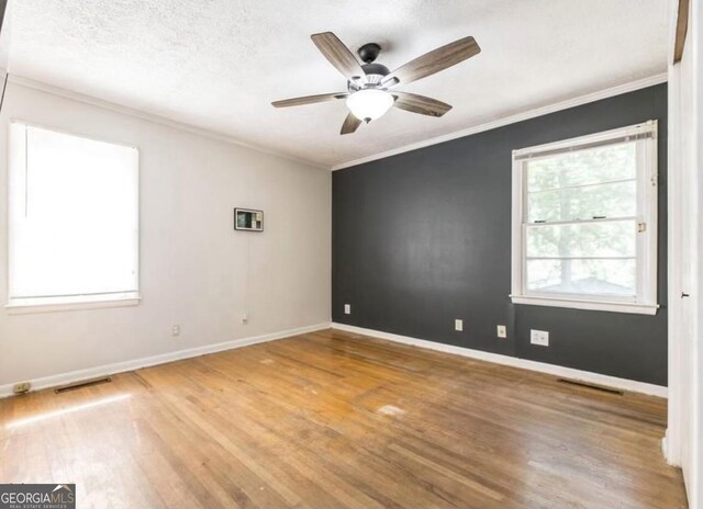 2982 Woodhaven Cir, Macon, GA 31204 - unfurnished room featuring wood finished floors, crown molding, baseboards, and a ceiling fan