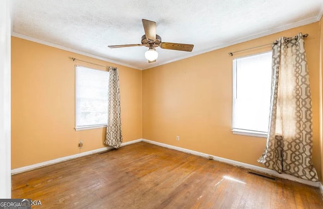 spare room featuring hardwood / wood-style floors, a textured ceiling, ceiling fan, and crown molding