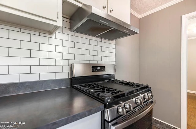 kitchen featuring white cabinets, hardwood / wood-style floors, and stainless steel range with gas stovetop