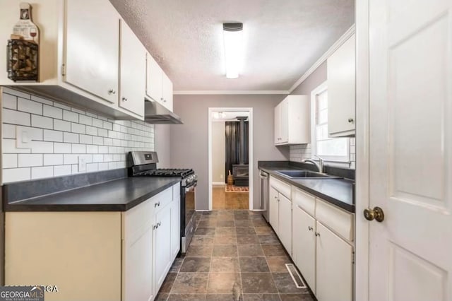 kitchen with backsplash, sink, ornamental molding, appliances with stainless steel finishes, and white cabinetry