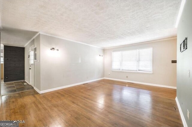 2982 Woodhaven Cir, Macon, GA 31204 - unfurnished room featuring wood finished floors, ornamental molding, a textured ceiling, and baseboards