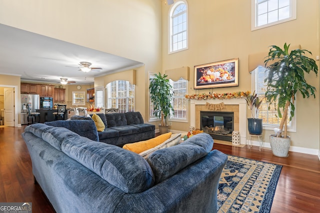 2202 Escalade Ct, Conyers, GA 30094 - living area featuring plenty of natural light, a tiled fireplace, dark wood-style flooring, a high ceiling, and a ceiling fan