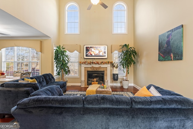 2202 Escalade Ct, Conyers, GA 30094 - living room featuring ceiling fan, a towering ceiling, wood finished floors, a fireplace, and plenty of natural light