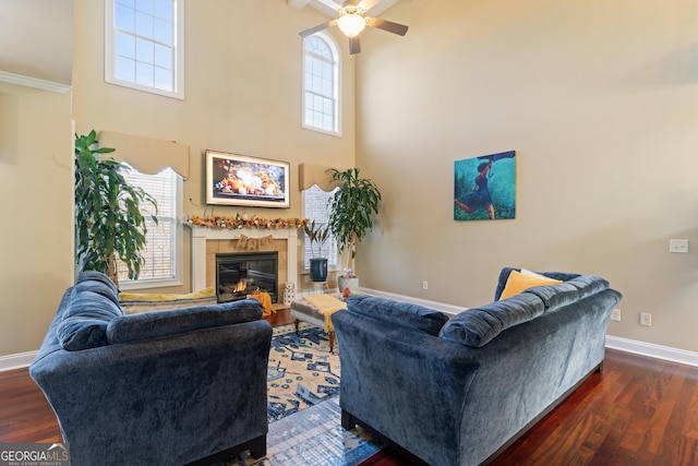 2202 Escalade Ct, Conyers, GA 30094 - living area featuring a ceiling fan, a tile fireplace, wood finished floors, healthy amount of natural light, and a towering ceiling