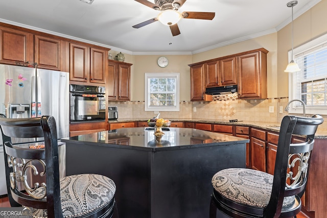 2202 Escalade Ct, Conyers, GA 30094 - kitchen featuring black appliances, under cabinet range hood, ceiling fan, a center island, and pendant lighting
