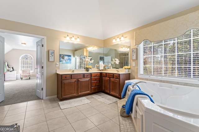 2202 Escalade Ct, Conyers, GA 30094 - bathroom featuring vaulted ceiling, double vanity, a tub with jets, and tile patterned floors