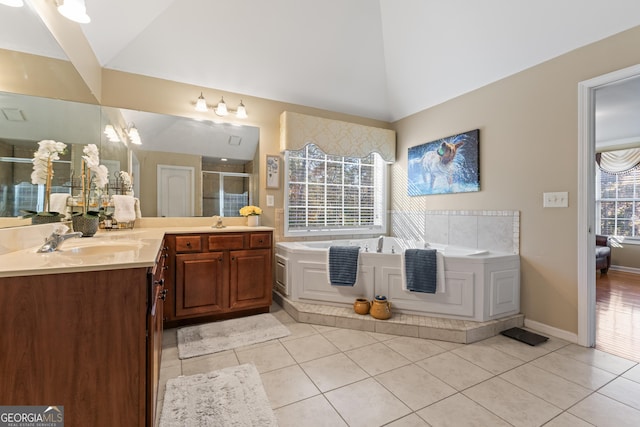 2202 Escalade Ct, Conyers, GA 30094 - full bath featuring vaulted ceiling, vanity, a stall shower, a bath, and tile patterned floors
