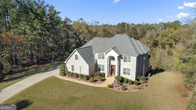 2202 Escalade Ct, Conyers, GA 30094 - view of front of house featuring a view of trees, a front lawn, a shingled roof, and driveway