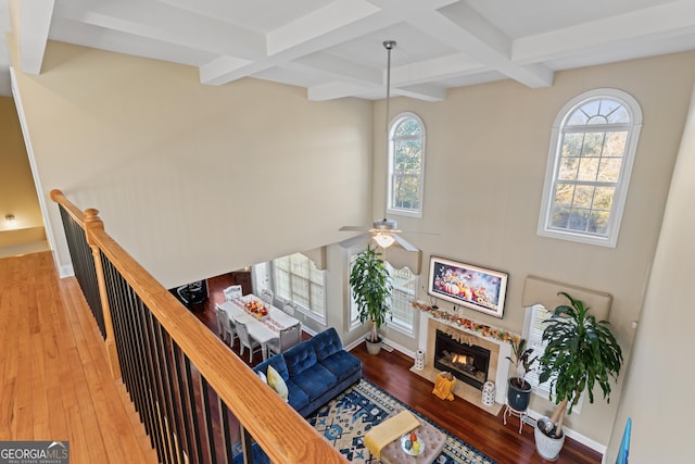 2202 Escalade Ct, Conyers, GA 30094 - living room with healthy amount of natural light, hardwood / wood-style floors, coffered ceiling, beamed ceiling, and a fireplace with flush hearth