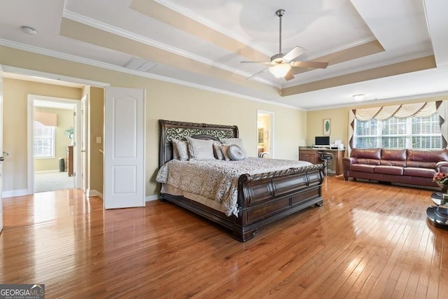 2202 Escalade Ct, Conyers, GA 30094 - bedroom featuring a tray ceiling, wood-type flooring, crown molding, and a ceiling fan