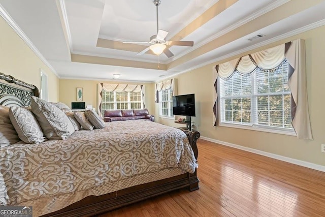 2202 Escalade Ct, Conyers, GA 30094 - bedroom featuring crown molding, hardwood / wood-style floors, a tray ceiling, and ceiling fan
