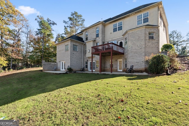 2202 Escalade Ct, Conyers, GA 30094 - back of property with brick siding, a patio, a yard, a deck, and french doors