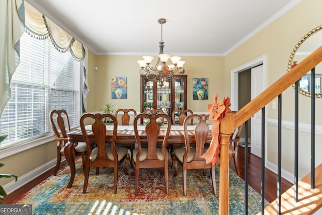 2202 Escalade Ct, Conyers, GA 30094 - dining space featuring plenty of natural light, a chandelier, wood finished floors, and crown molding